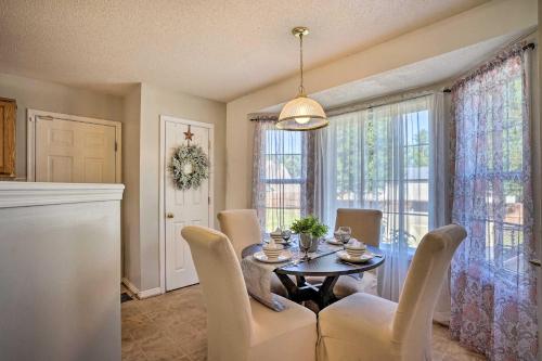 a dining room with a table and chairs and windows at 9 Mi to Richmond Sandston Home with Office in Sandston