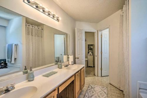 a bathroom with two sinks and a large mirror at Charming Sandston Home about 9 Mi to Richmond! in Sandston