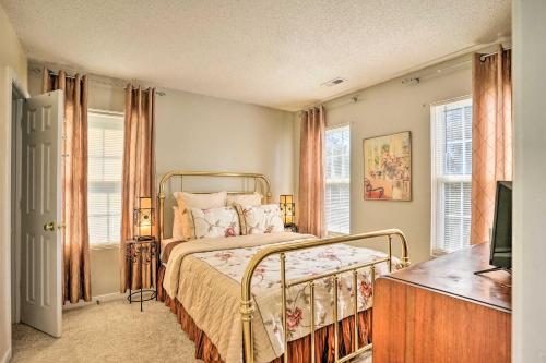 a bedroom with a bed and two windows at 9 Mi to Richmond Sandston Home with Office in Sandston