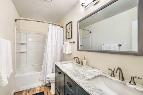 a bathroom with a sink and a toilet and a mirror at Sunny Phoenix Home with Pool and Backyard Oasis! in Phoenix