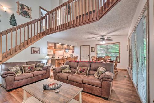 a living room with two couches and a staircase at Picturesque Pigeon Forge Cabin with Mountain Views in Pigeon Forge