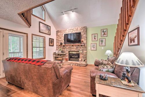 a living room with a couch and a fireplace at Picturesque Pigeon Forge Cabin with Mountain Views in Pigeon Forge