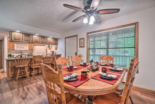 a kitchen and dining room with a table and chairs at Picturesque Pigeon Forge Cabin with Mountain Views in Pigeon Forge