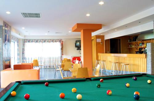 a living room with a pool table in a room at HI Foz Coa - Pousada de Juventude in Vila Nova de Foz Coa