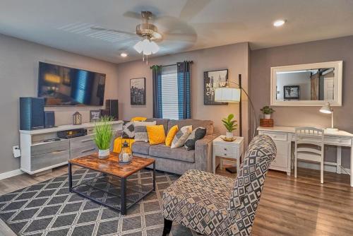 a living room with a couch and a table at Cozy Haven Attached to Million Home - South Tampa in Tampa