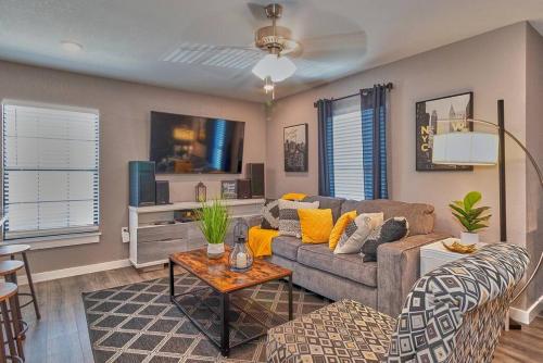 a living room with a couch and a table at Cozy Haven Attached to Million Home - South Tampa in Tampa