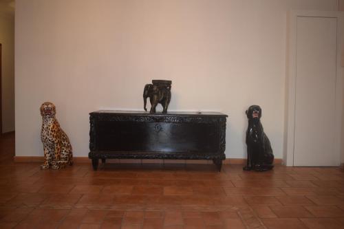 three statues of cats sitting on a table in a room at Saint Julians Seafront 200m2 beautiful Apartment in Tal-Għoqod