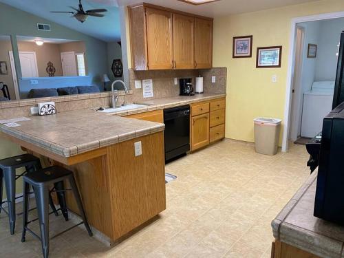 a kitchen with wooden cabinets and a counter top at Waxberry Getaway Sequoia/Kings Canyon National Pks in Squaw Valley