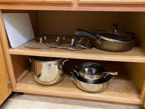 three pots and pans on a shelf in a cabinet at Waxberry Getaway Sequoia/Kings Canyon National Pks in Squaw Valley