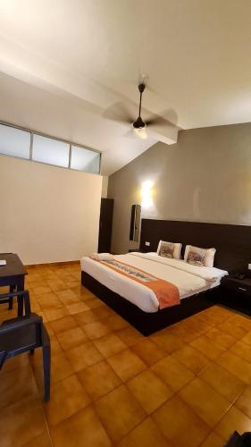a bedroom with a large bed and a ceiling at Garden Villa in Vagator