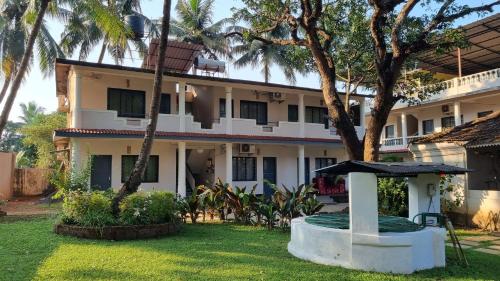 a house with a garden in front of it at Garden Villa in Vagator