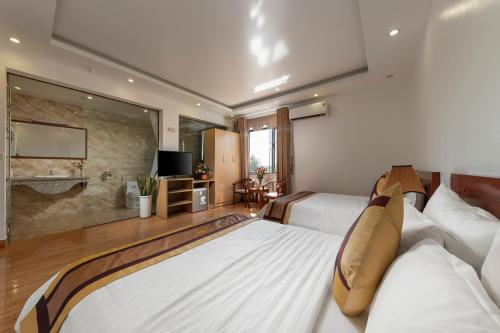 a hotel room with two beds and a large window at Airport Transit Hotel in Hanoi
