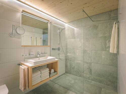 a bathroom with a sink and a shower at Felder Apartments in Schoppernau