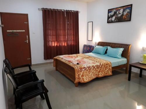 een slaapkamer met een bed en een stoel erin bij Aden Valley, kanthalloor in Kanthalloor