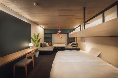 a bedroom with a large bed and a living room at Takamiya Hotel Jurin in Zao Onsen
