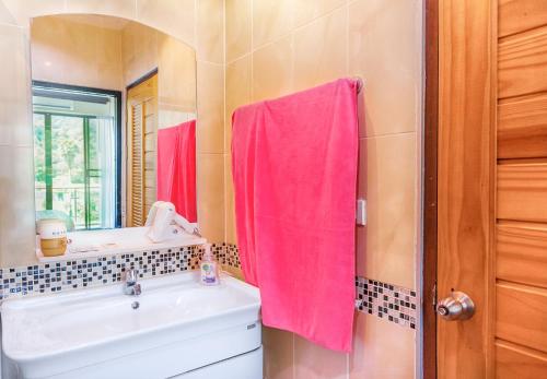 a bathroom with a sink and a pink towel at The Nai Thon Condominium Unit in Nai Thon Beach