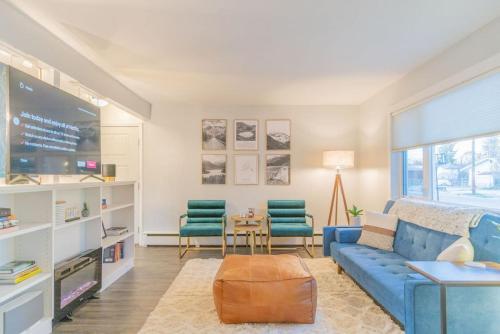 a living room with a blue couch and two chairs at Taku's Contemporary & Stylish Private Retreat in Fairbanks
