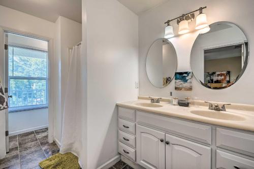 a bathroom with a sink and a mirror and a window at Lovely East Point Home Less Than 8 Mi to Downtown ATL in Atlanta