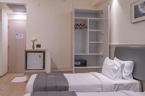a bedroom with a bed and a tv in it at REPUBLIC INN in Tirupati