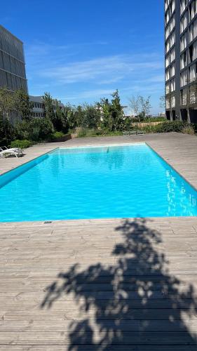 a shadow of a building with a blue pool at Orpheu Deluxe Apt - Parque das Nações in Lisbon