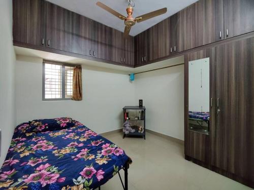 a bedroom with a bed and a ceiling fan at Comfy 2-bedroom House in Sanjaynagar, Bengaluru in Bangalore