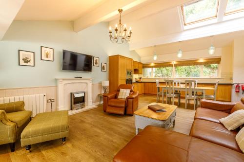 a living room with a couch and a fireplace at Loch Rannoch Highland Club in Kinloch Rannoch