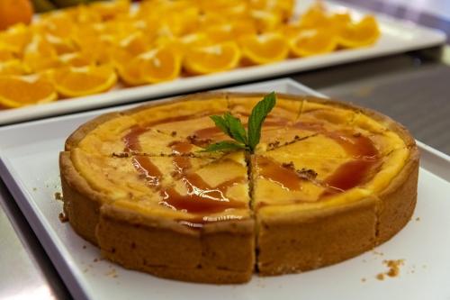 a orange pie on a plate with a garnish at Gaia Village in Tigaki