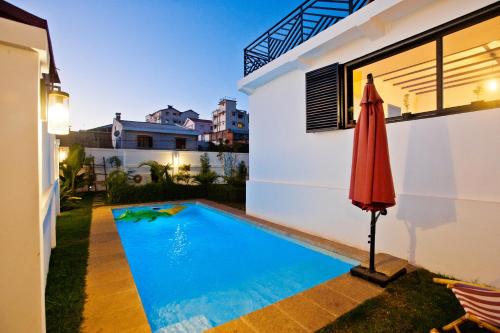 a swimming pool in the backyard of a house at Joyau secret # Jardin # Piscine # Bien-être # prox centre ville in Antananarivo