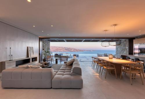 a living room with a couch and a dining room at Untold Mykonos in Mikonos