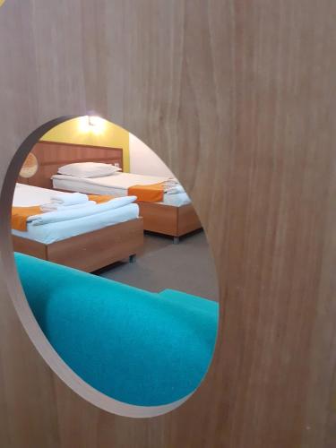 a room with two beds and a mirror at Hotel Les in Razgrad