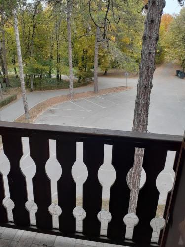 a view of a park from a balcony with a fence at Hotel Les in Razgrad