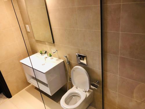 a bathroom with a toilet and a sink and a shower at 1-Bedroom on Forest Island & Oceanside View in Salalah