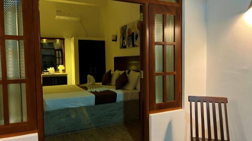 a bedroom with a bed in a room at Sea Pink Residence in Bentota