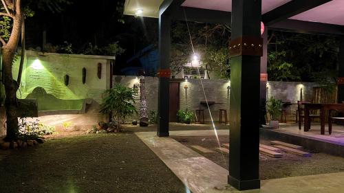 a garden at night with a green wall at Sea Pink Residence in Bentota