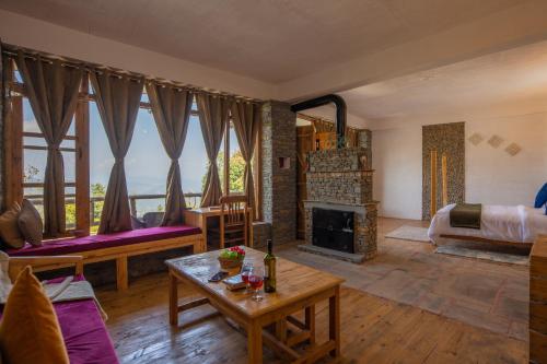 a living room with a couch and a fireplace at THE CEDAR CASTLE in Mukteswar