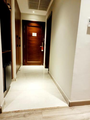 a hallway with a wooden door in a building at Best Western Premier Hotel Gulberg Lahore in Lahore