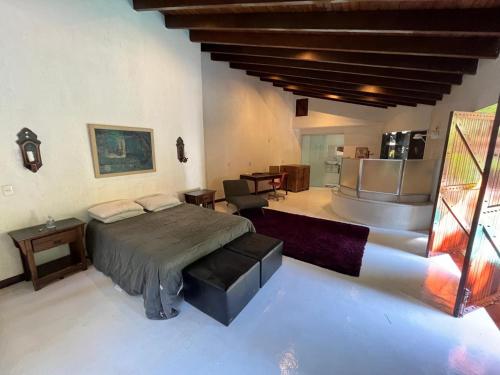 a bedroom with a bed and a table and chairs at Casa Solar in Rio de Janeiro