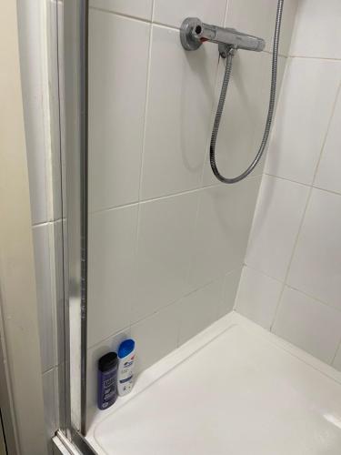 a shower with a shower head in a bathroom at Ashdale Guest House Liverpool in Liverpool