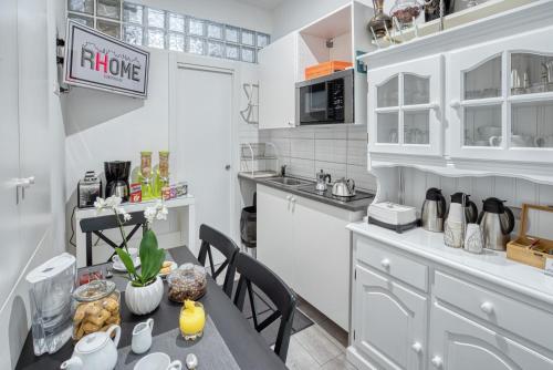 a kitchen with a table and chairs in a room at Rhome Guest House in Rome