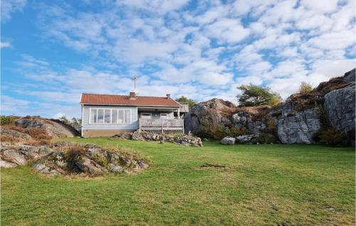a small house in a field with rocks at 3 Bedroom Stunning Home In Kyrkesund in Kyrkesund
