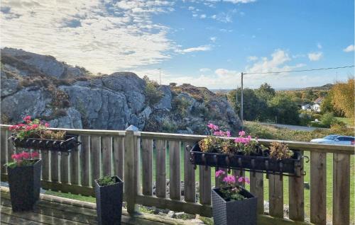 a wooden fence with potted plants on it at 3 Bedroom Stunning Home In Kyrkesund in Kyrkesund