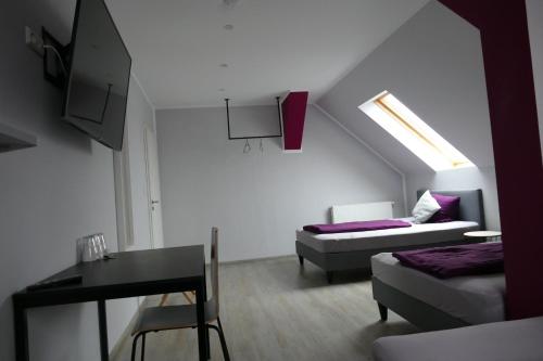 a living room with a bed and a table and a couch at Pension Sölde UG in Dortmund