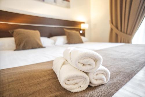 a pile of towels sitting on top of a bed at Mainake Costa del Sol in Torre del Mar