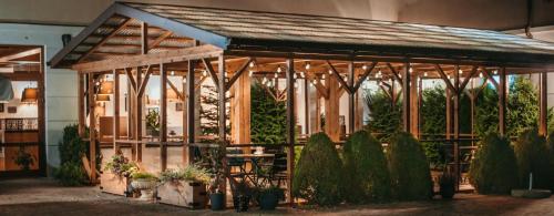 a greenhouse with a table and chairs in a building at Apartamenty Gala in Sułkowice