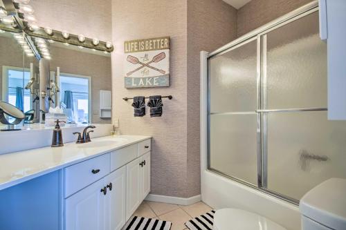 a bathroom with a shower and a sink and a mirror at Lake Views and Pool Access Lake Ozark Condo! in Lake Ozark