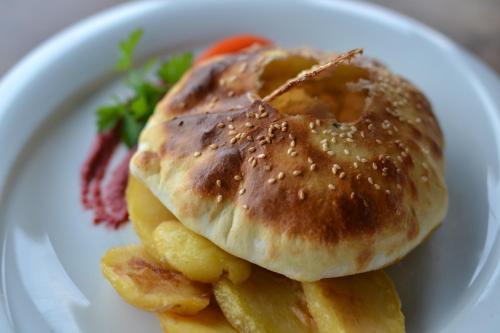 a plate of food with a bagel and french fries at Ciflik Winery in Bitola