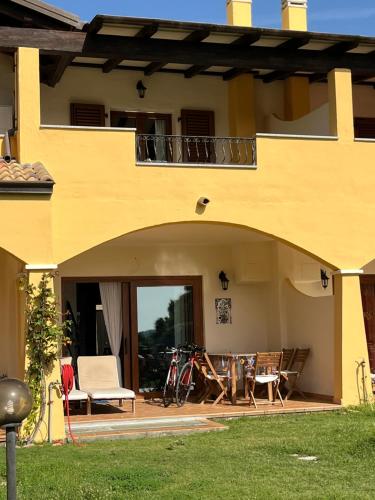 a yellow house with a patio with a table and chairs at La Marea in Chia