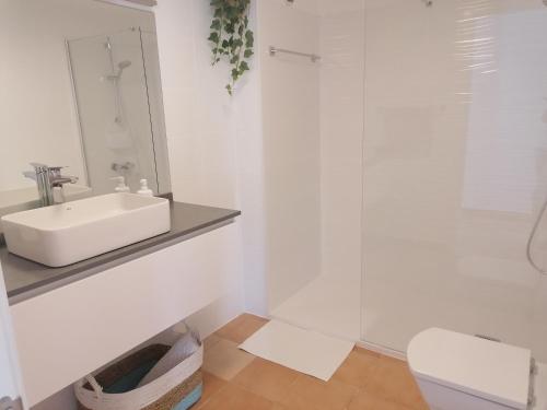 ein weißes Bad mit einem Waschbecken und einem WC in der Unterkunft Casa Reina in Gran Tarajal