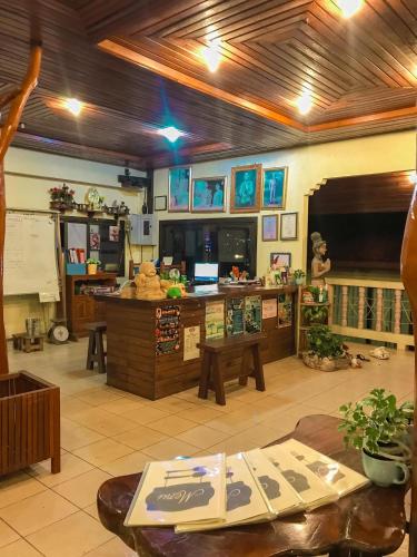a living room with a desk and a table at Tanouy Garden in Baan Khai