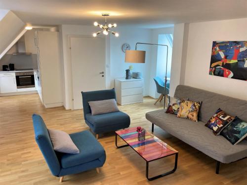 a living room with a couch and two chairs and a table at Carillon by BestChoice - Old City - Self Check-in with PARKING option in Graz